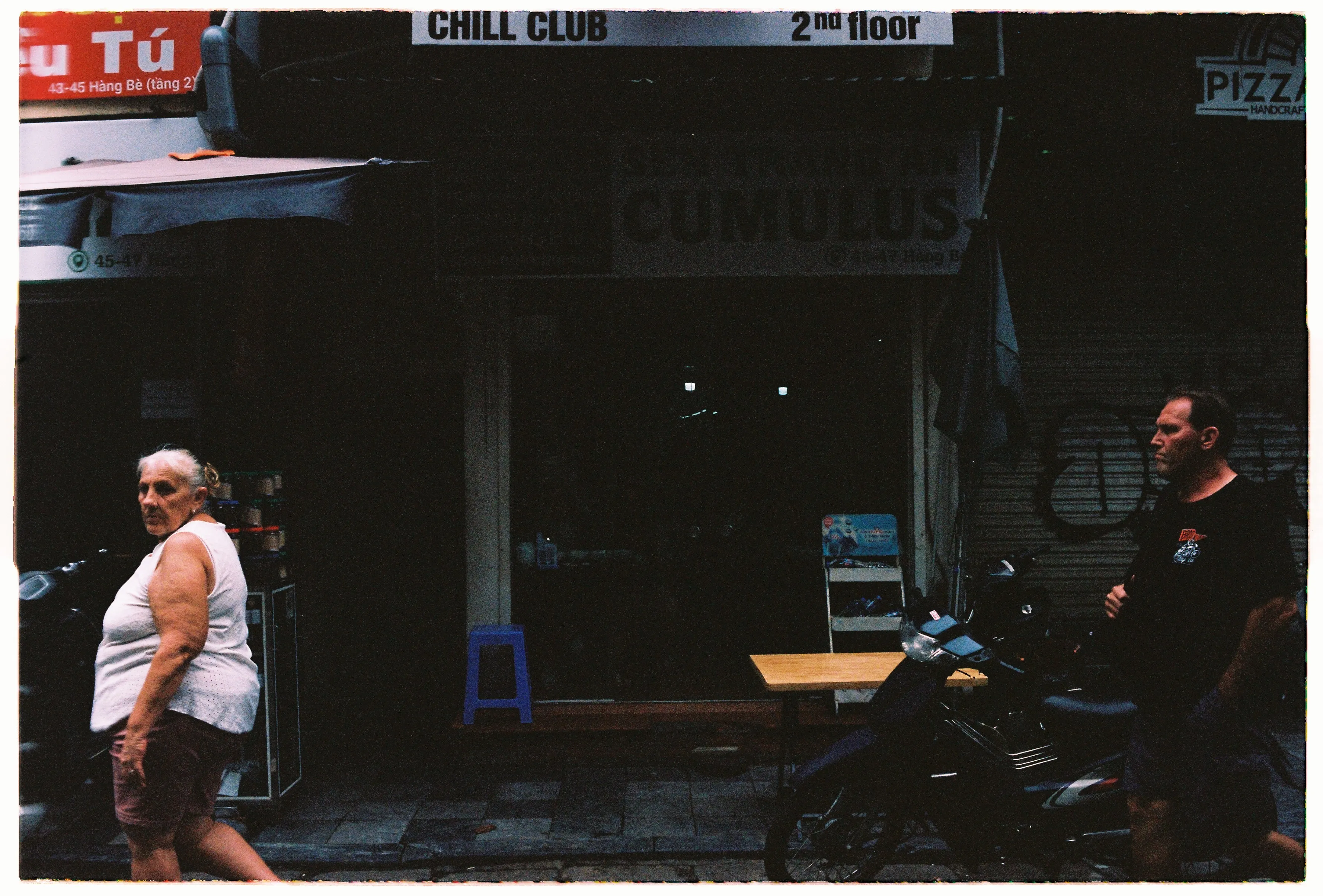Film photograph from Thailand, titled "lady walking".